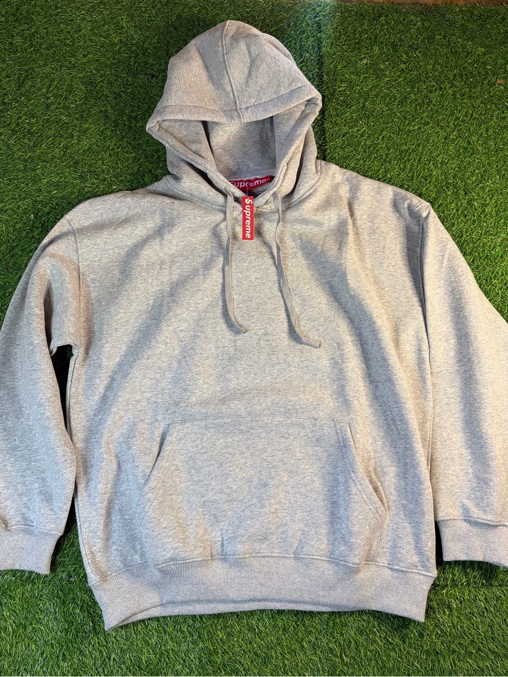 Supreme Light Gray Hoodie with Red Tag